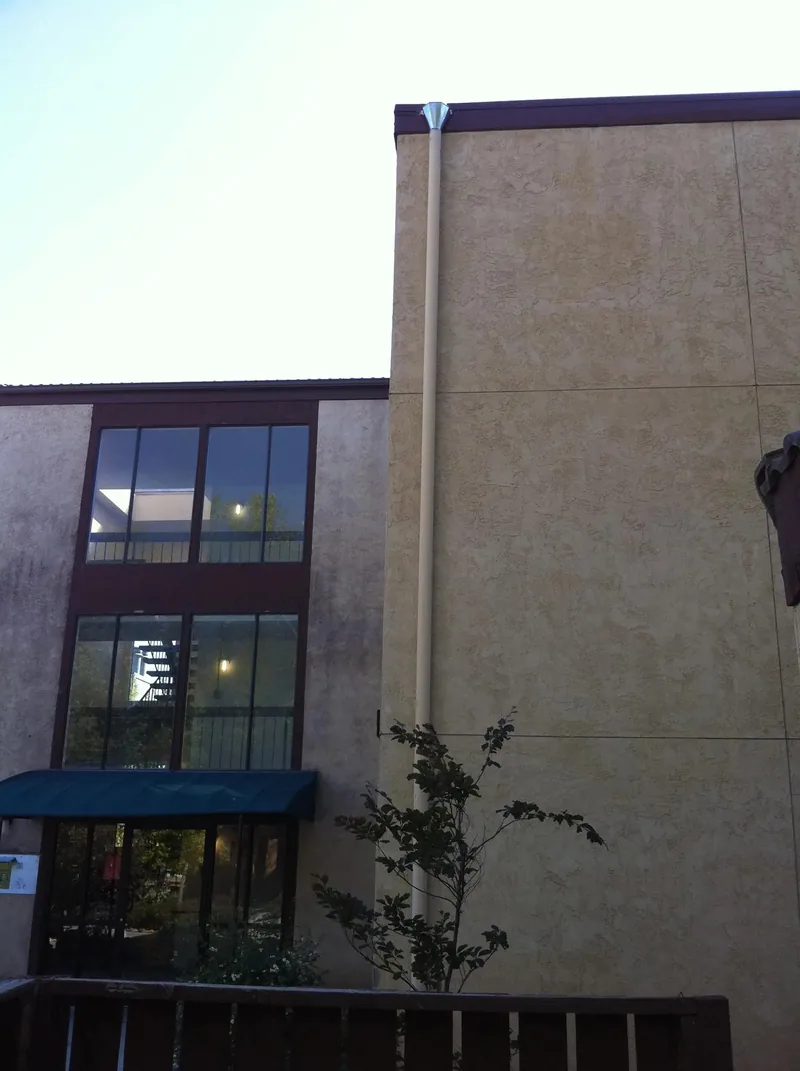Commercial stucco building with oversize downspout in Reno