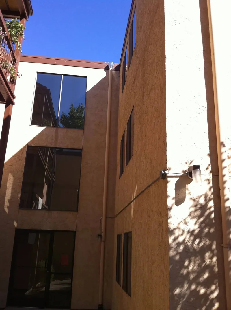 Professional office building courtyard with scupper-to-downspout drainage